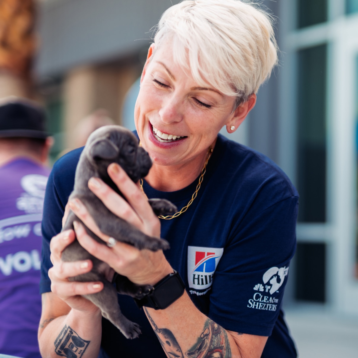 A woman holding a puppy